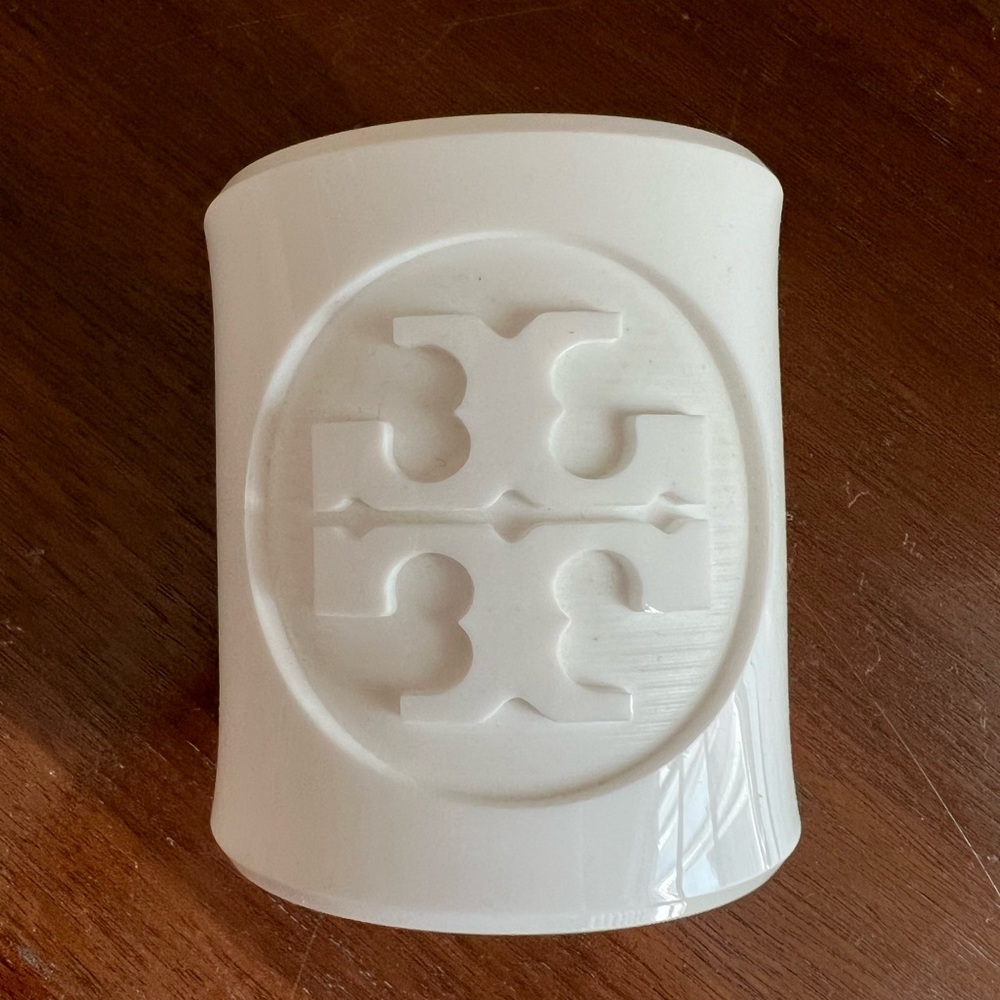 Tory Burch white acrylic cuff. Pre-owned but I’m very good condition.
